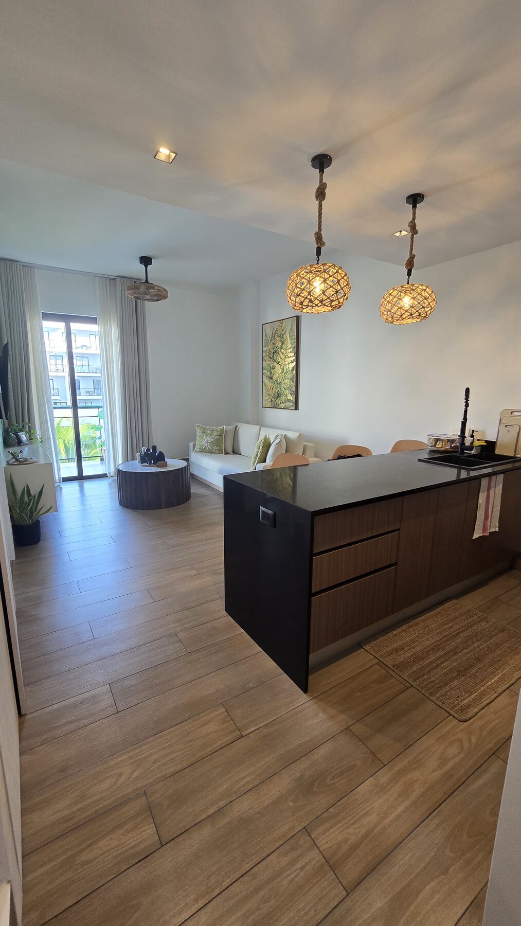 Open plan kitchen and living room leading to the balcony doors